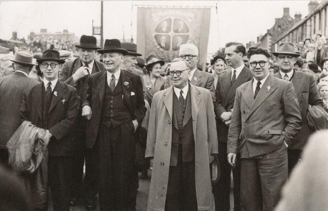 Photograph of the Northumberland Miners' Picnic with Clement Attlee. In the background is an unidentified miners' union branch banner.