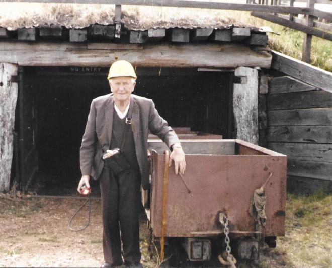 Tommy at entrance to Wonthaggi mine tunnel during his time as a guide, after his retirement and after the mine closed. Note the battery and safety light which he is carrying.