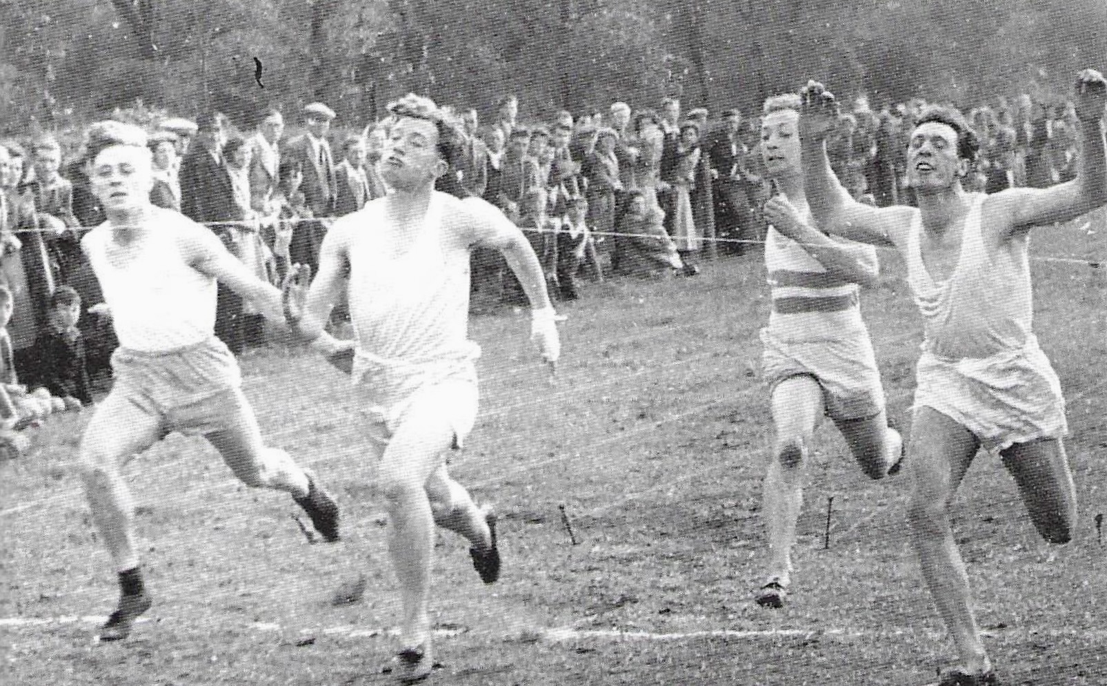Willy Lyons (running as W. Weaver), second from left, breaks the tape to win a race in Hirst Park, Ashington, 1949